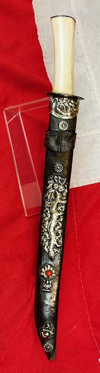 A Most Interesting & Unusual Form of Antique Tibetan Buddhist Large Dagger-Short Sword. A Dpa'dam. Decorated With Repousse Dragon and Buddha, Seated in the Padmasana Pose, in Dhyana Mudra, With Mandorla, a Coral Stone Bead Inset & Unalome Spiral Sun