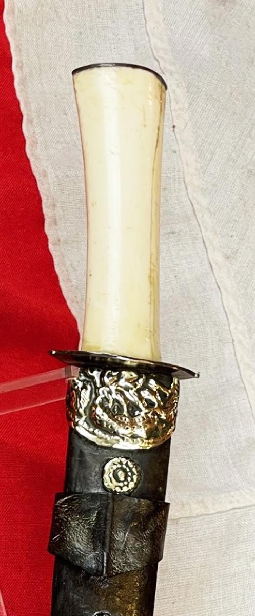 A Most Interesting & Unusual Form of Antique Tibetan Buddhist Large Dagger-Short Sword. A Dpa'dam. Decorated With Repousse Dragon and Buddha, Seated in the Padmasana Pose, in Dhyana Mudra, With Mandorla, a Coral Stone Bead Inset & Unalome Spiral Sun