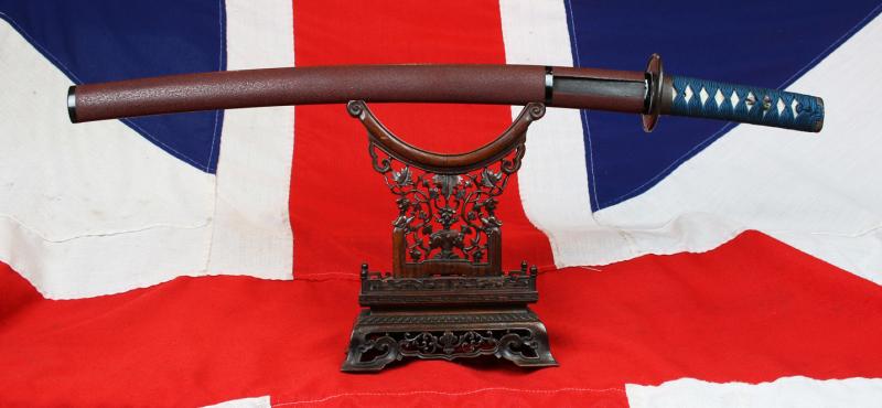 A Good Yoshii School Wakazashi, Likely Muromachi, Signed Yoshii Mitsunori Dressed With A Stunning Livery of Brown Ishime Lacquer Complimented With a Finest Blue Silk Tsukaito Hilt Wrap