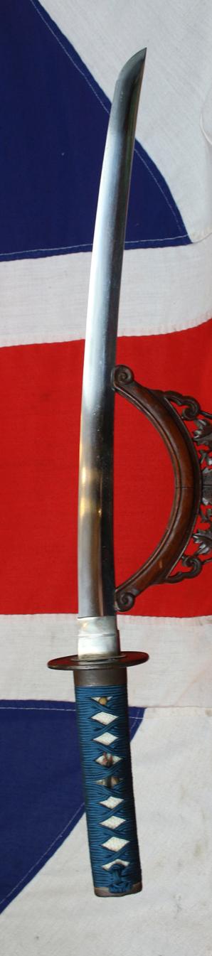 A Good Yoshii School Wakazashi, Likely Muromachi, Signed Yoshii Mitsunori Dressed With A Stunning Livery of Brown Ishime Lacquer Complimented With a Finest Blue Silk Tsukaito Hilt Wrap