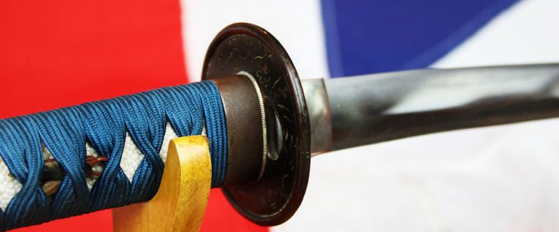 A Good Yoshii School Wakazashi, Likely Muromachi, Signed Yoshii Mitsunori Dressed With A Stunning Livery of Brown Ishime Lacquer Complimented With a Finest Blue Silk Tsukaito Hilt Wrap